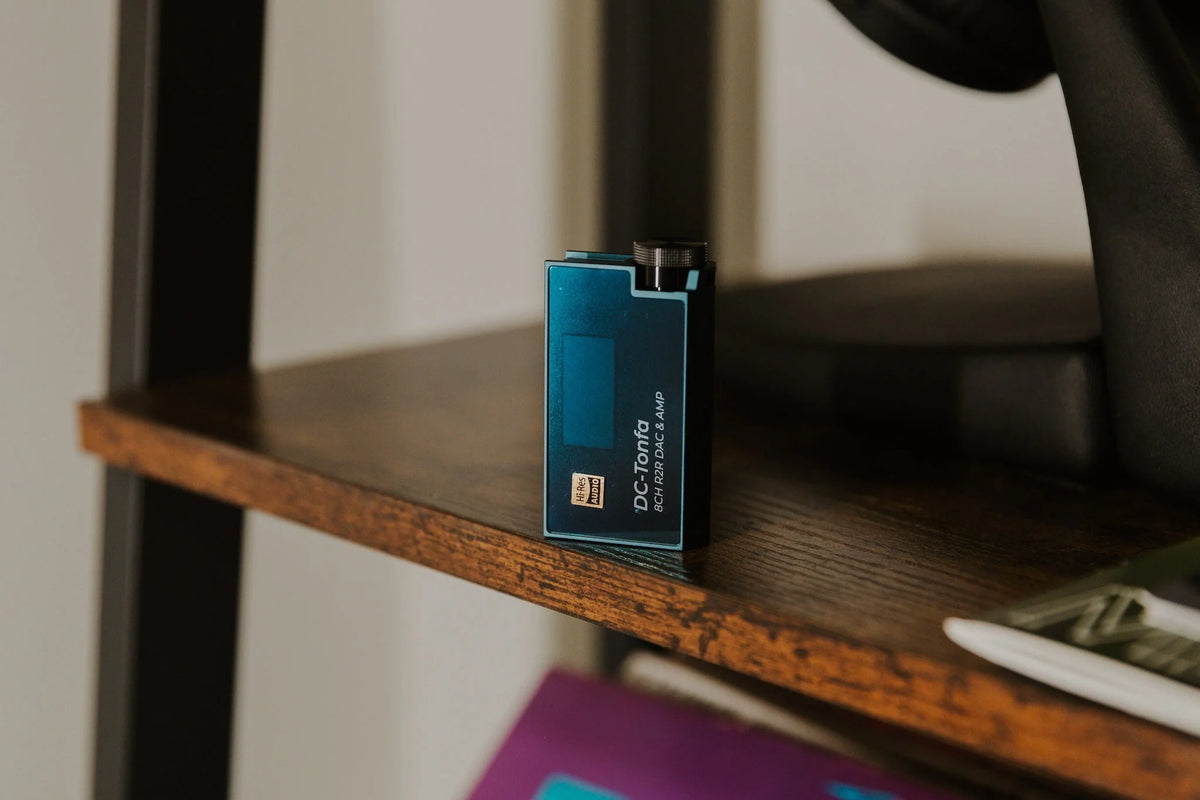 iBasso DC-Tonfa in blue on a dark wooden shelf